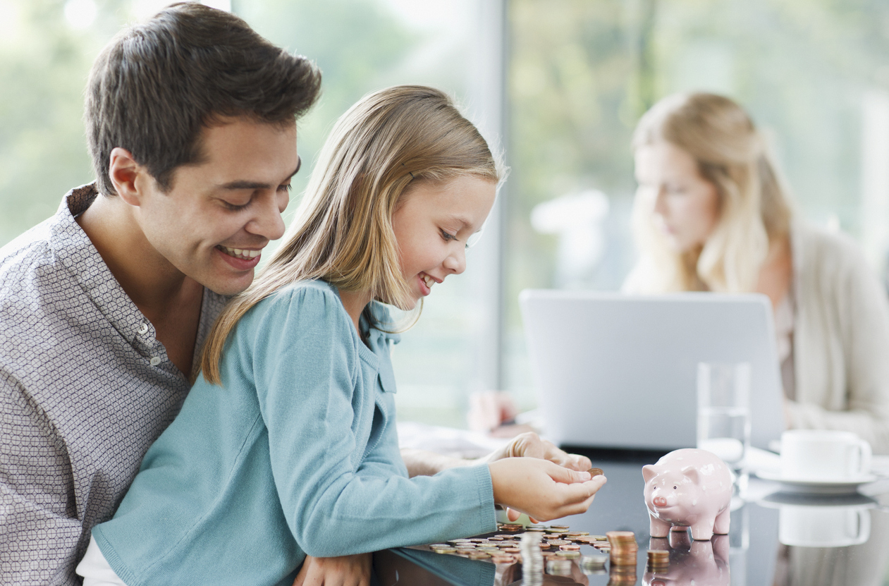 Father watching daughter count coins