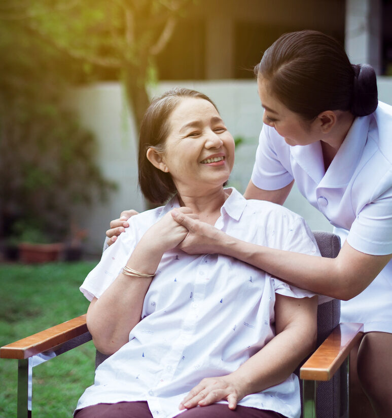 Nurse holding hands to elderly Asian woman with Alzheimer disease,Positive thinking,Happy and smiling,Take care and support concept